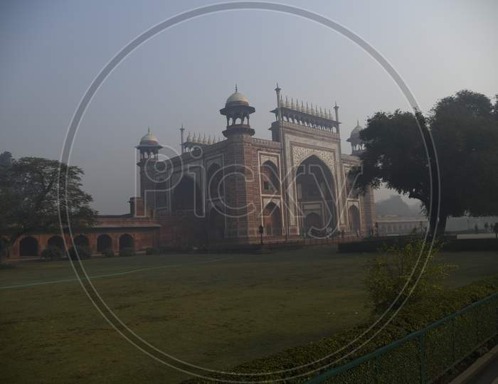 Morning view of Darwaza-i-rauza of Taj Mahal with fog