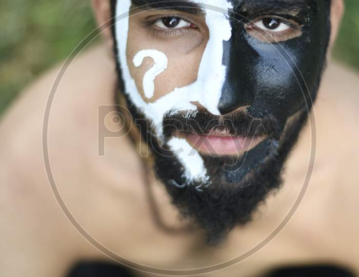 Portrait of Indian Male Model with black and white face paint