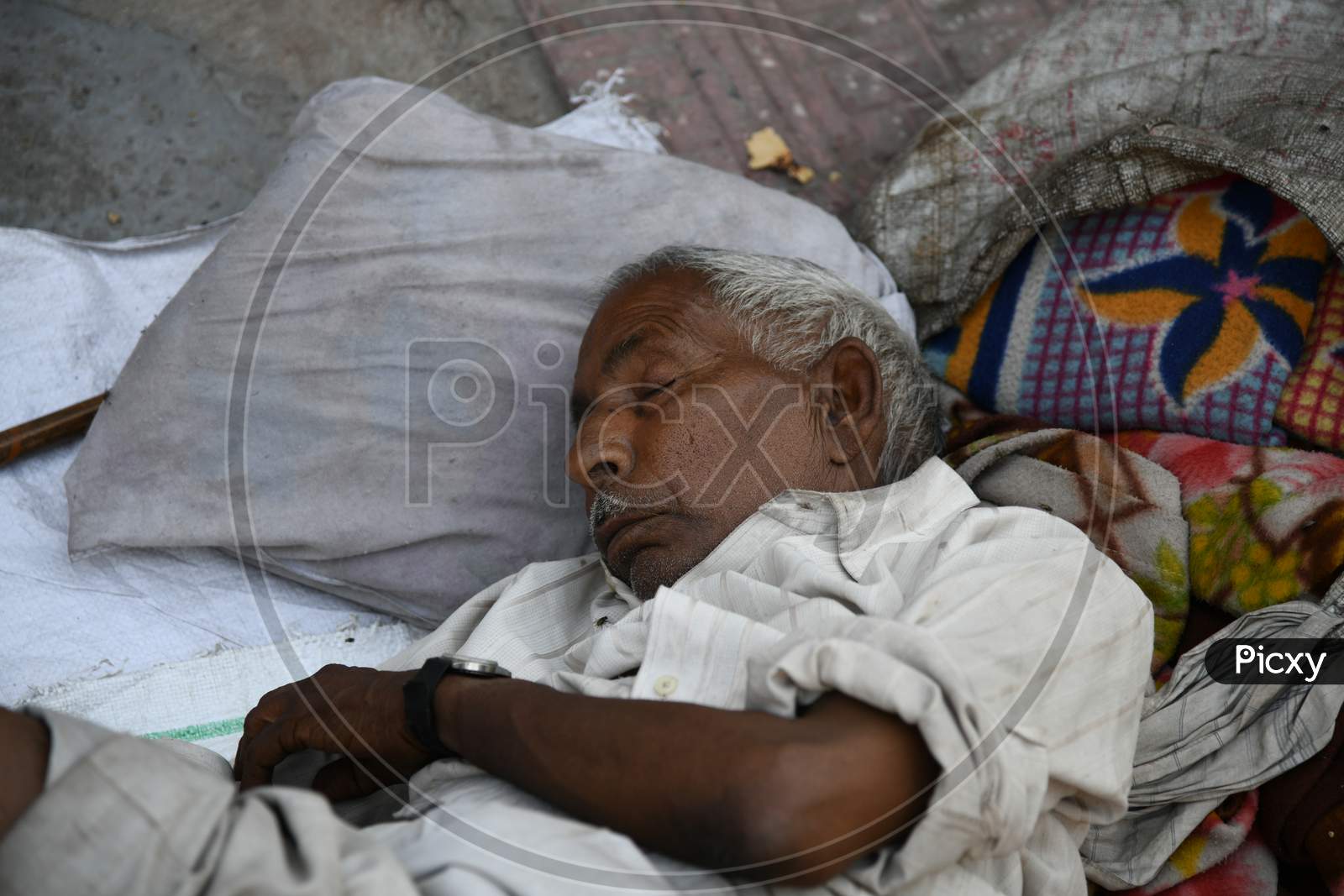 A Homeless Old Man Sleeping On Railway Station Platform