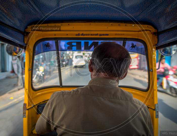 View from the inside of an auto-rickshaw in India,  the Hindu God's name 'Sri Veera Kaali' is written above the windshield