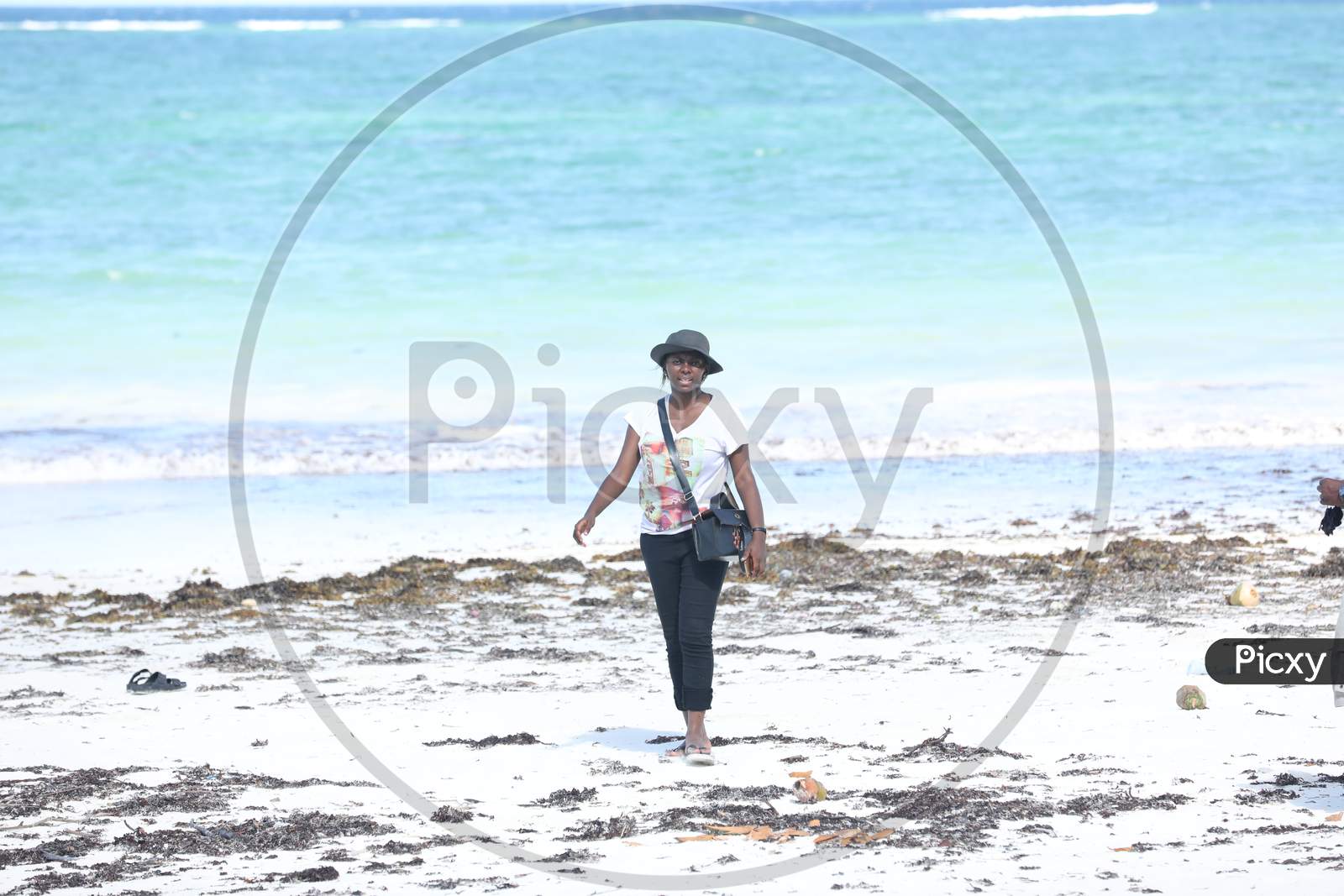A Kenya woman standing by the beach