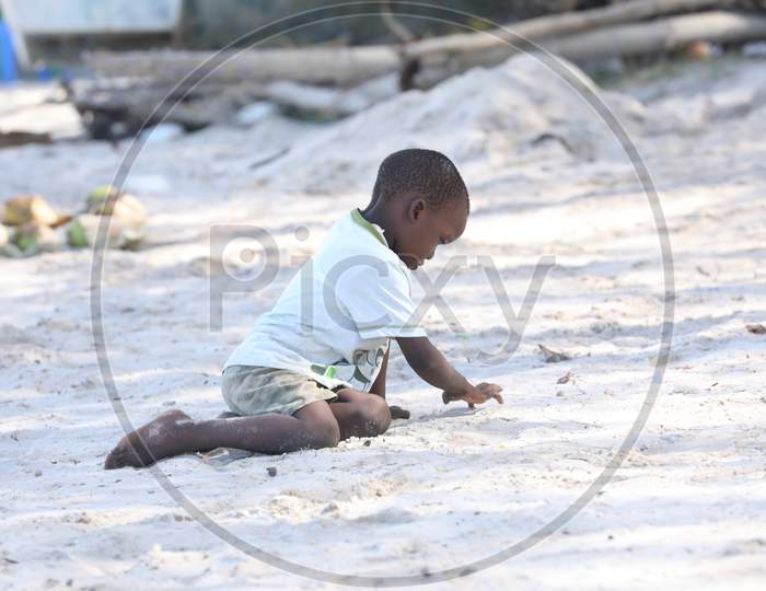 A Little Kenya boy playing by the beach