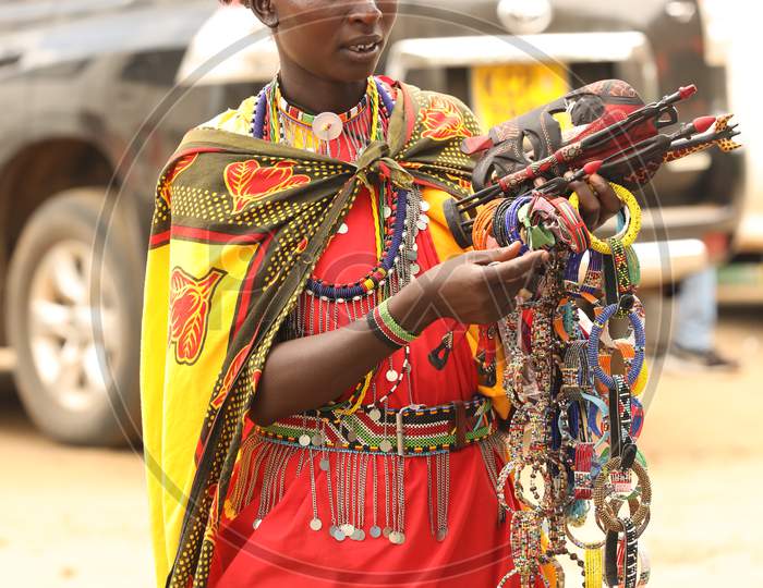 Maasai Tribal Woman Selling Hand Made Articles To Tourists Of Masai Mara National Conservancy , Kenya