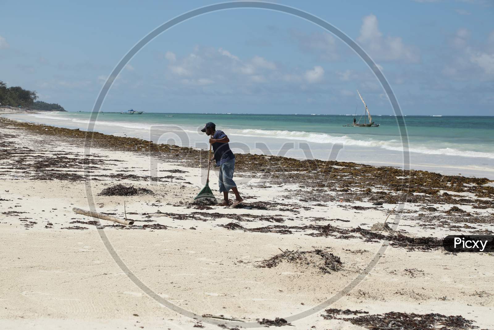 Sweepers Cleaning The Beach In Kenya