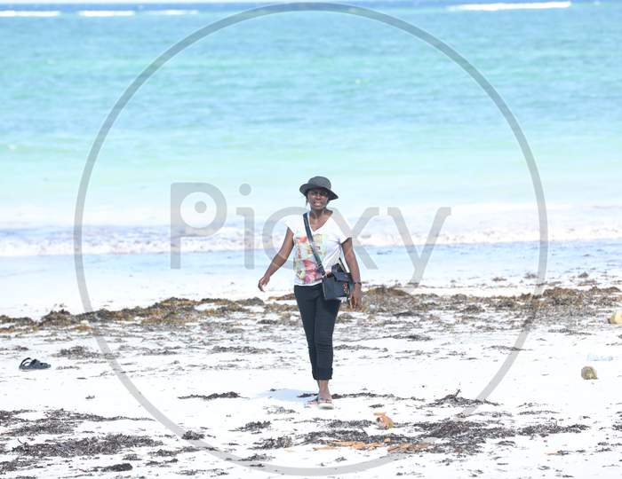 A Kenya woman standing by the beach