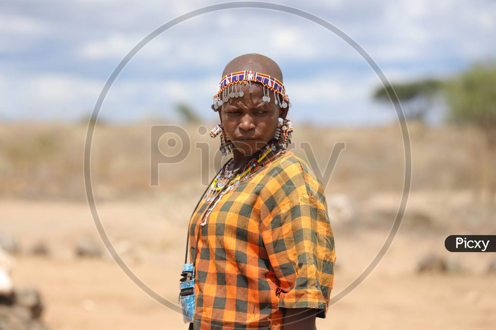 A Kenya Woman wearing yellow checkered shirt