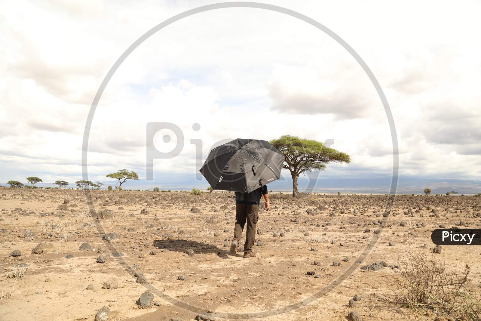 A man walking with an umbrella in Kenya