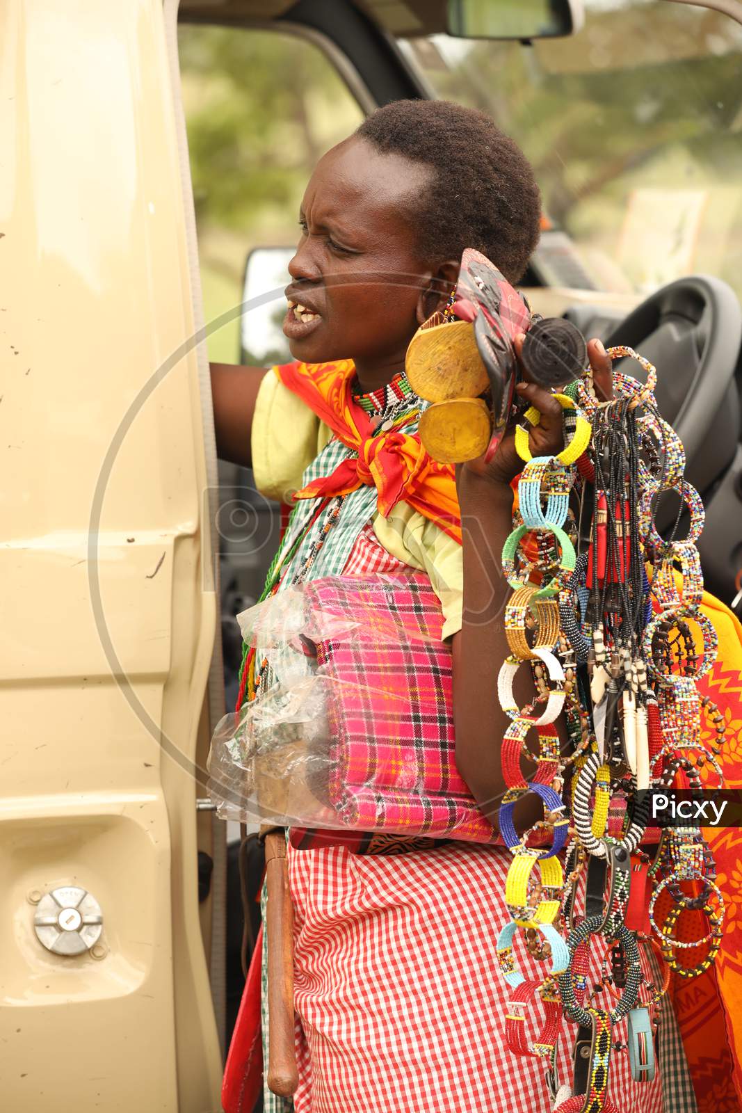 Maasai Tribal Woman Selling Hand Made Articles To Tourists Of Masai Mara National Conservancy , Kenya