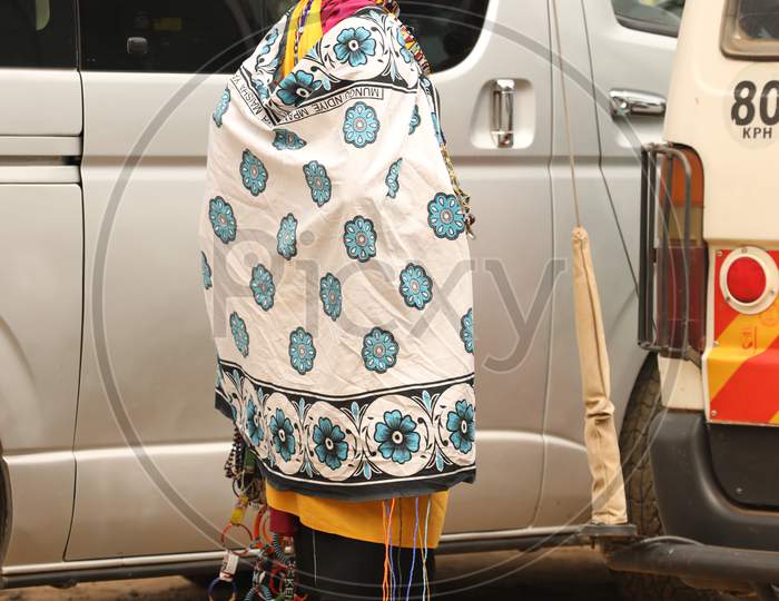 A Tribal Woman standing by the car