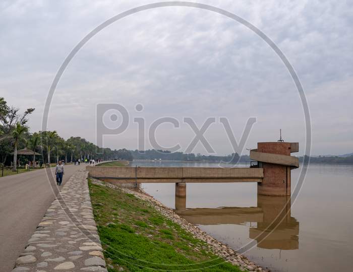 people walking alongside sukhna lake i the morning and sukhna gallery at the lake in chandigarh