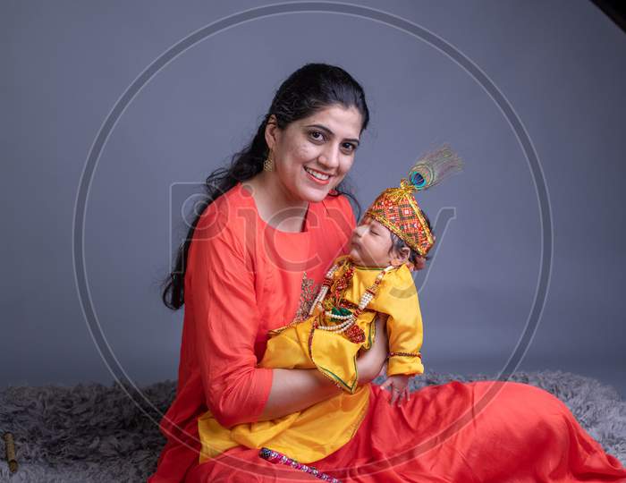Indian Mother With A Baby In Lord Krishna Clothes