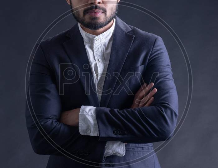 Young Indian Male Model Wearing Suite  And Posing Over Grunge Wall Background