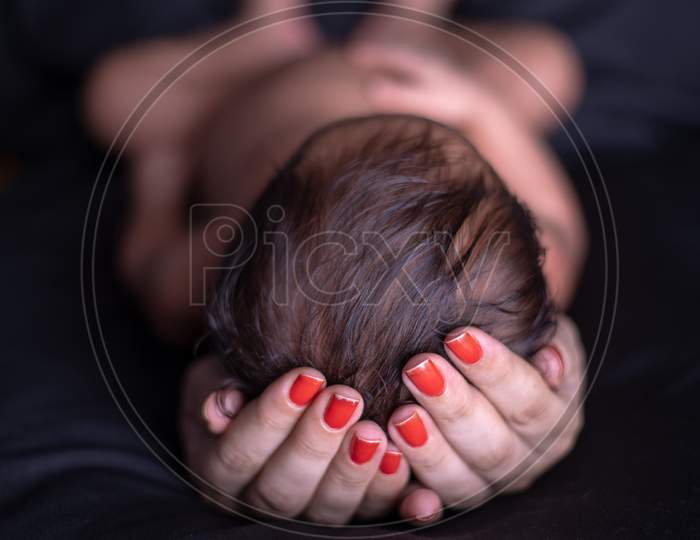 Mother Holding A Baby In Hands Closeup