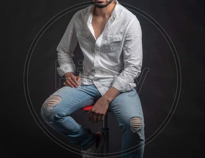 Portrait of Attractive Indian Male Model  With an Expression Over an Black Background