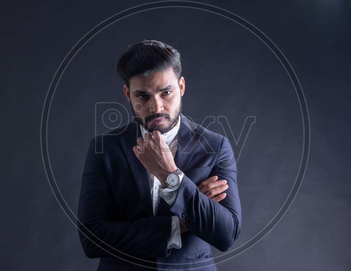 Young Indian Male Model Wearing Suite Posing Over Grunge Wall Background