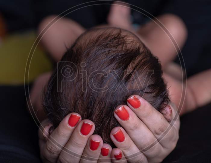 Mother Holding A Baby In Hands Closeup