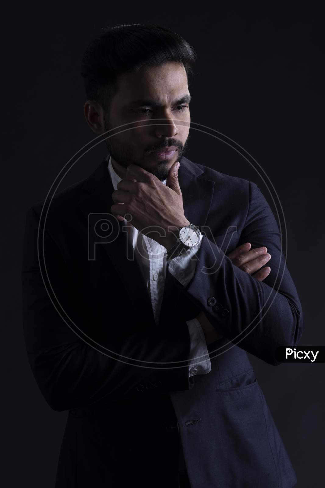Young Indian Male Model Wearing Suite Posing Over Grunge Wall Background