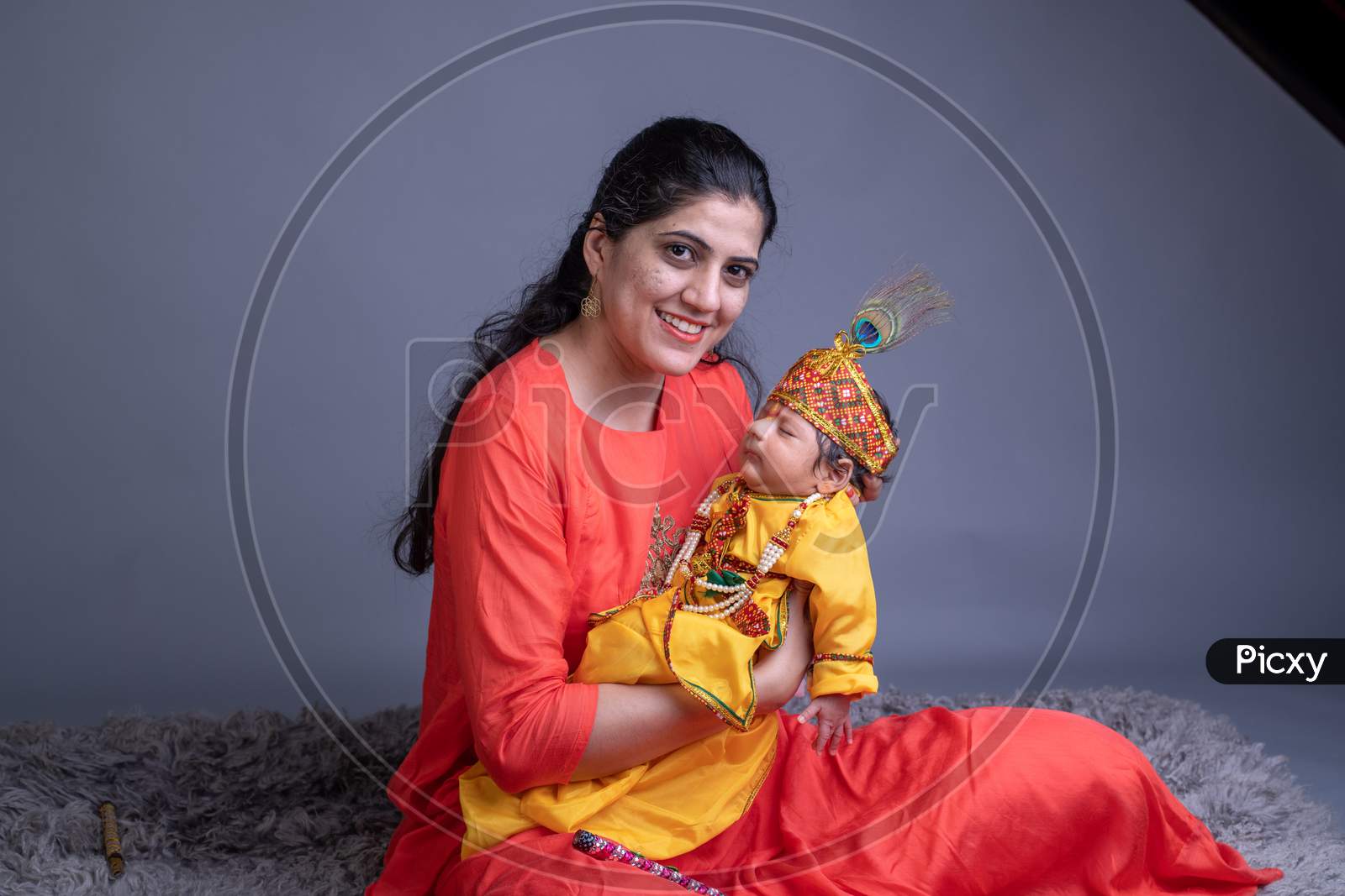 Indian Mother With A Baby In Lord Krishna Clothes