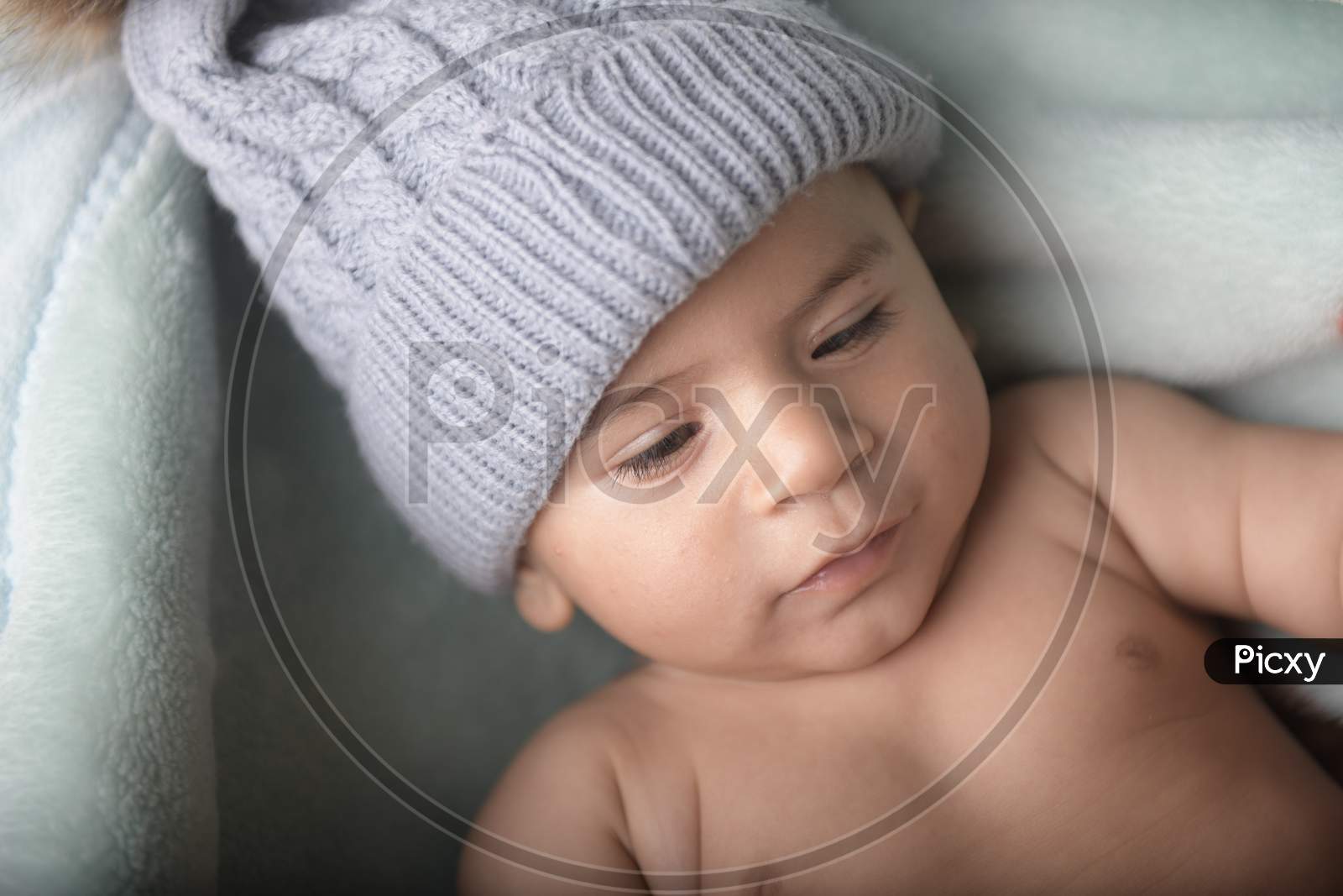 Cute Little Baby Girl Wearing Woolen Cap Face Closeup With a Smile And Innocent Expression