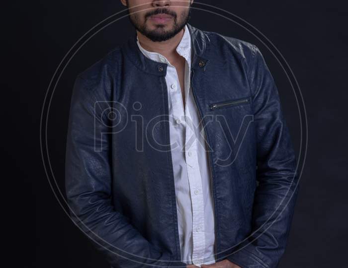 Portrait of Attractive Indian Male Model  With an Expression Over an Black Background