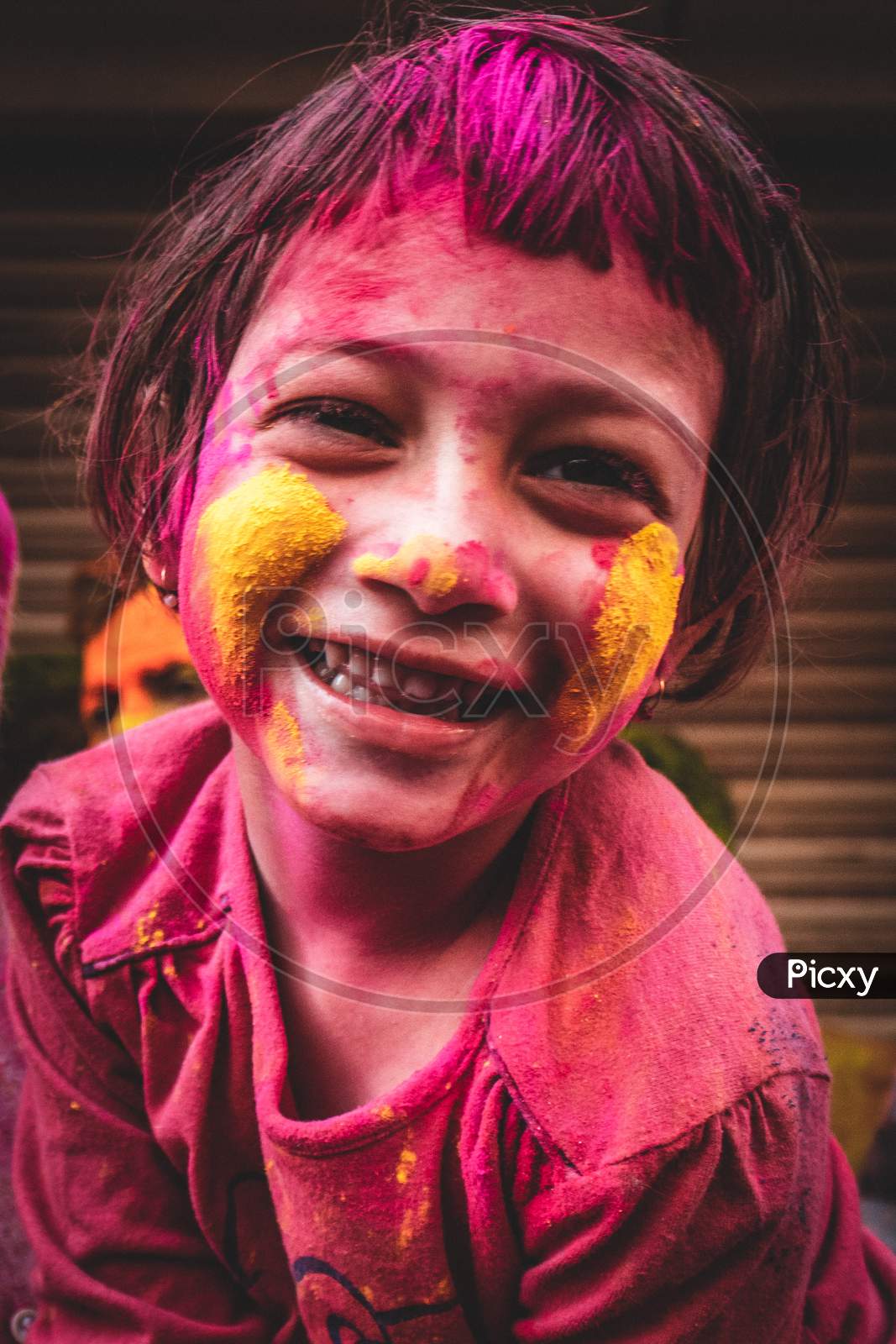 Smiling face of a girl with colours on holi day