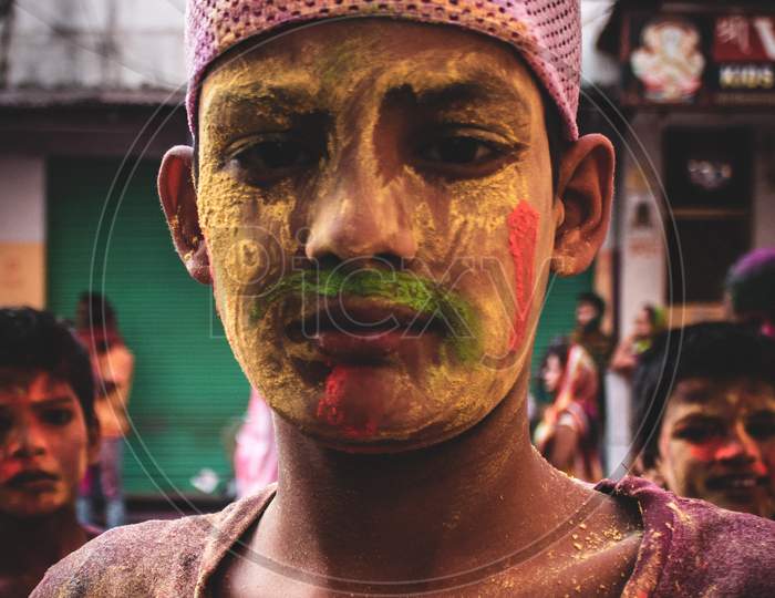 A muslim boy with colours on his face