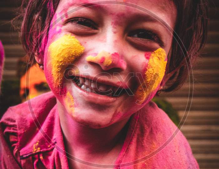 Smiling face of a girl with colours on holi day