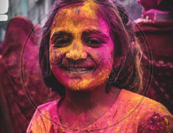 Portrait of a girl playing holi