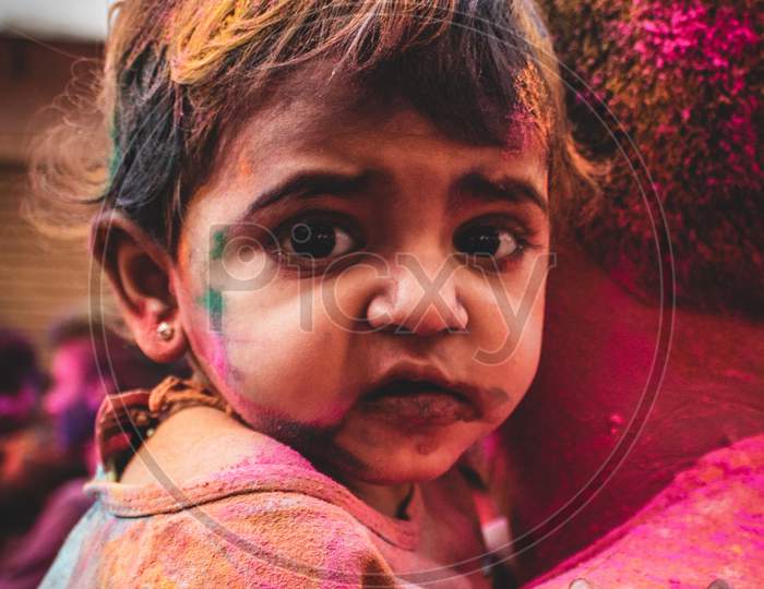 Portrait of a girl playing holi