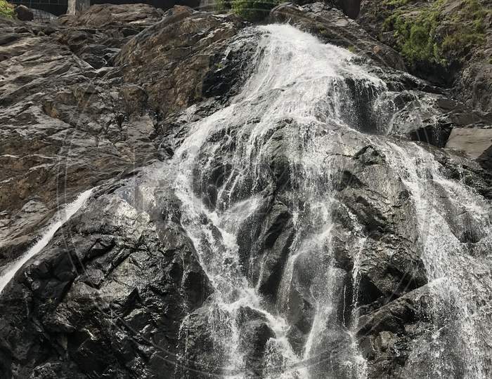 Water Falls Falling From a Rock Hill Cliff