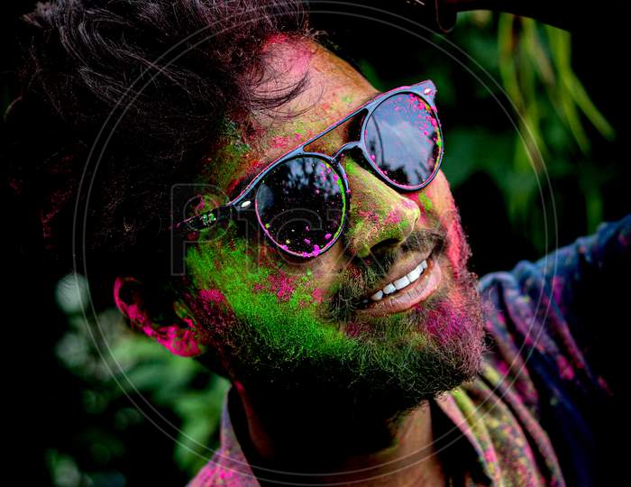 Portrait of a person playing holi.