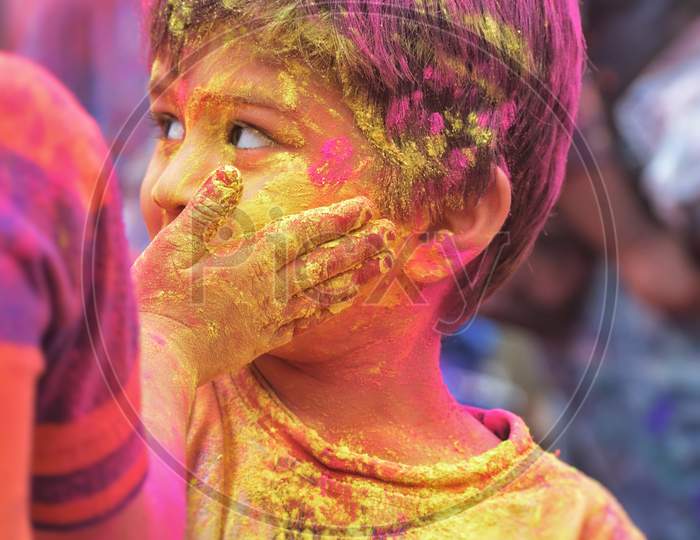 A little boy celebrating Holi in the streets of Hyderabad