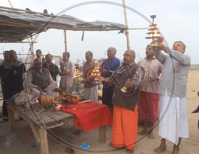 Indian Hindu Priest Performing Haarathi Or Aatrhi  To Triveni Sangam River In Prayagraj