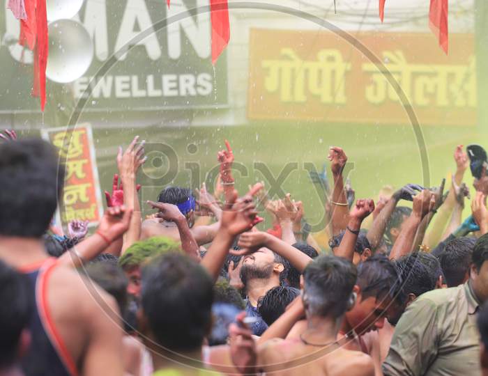 Crowd Of Young Indian People Celebrating Holi Festival With Colour Splash