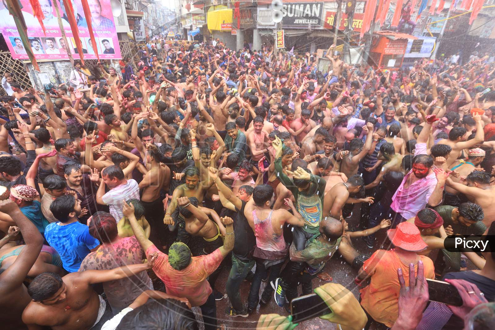 Crowd Of Young Indian People Celebrating Holi Festival With Colour Splash