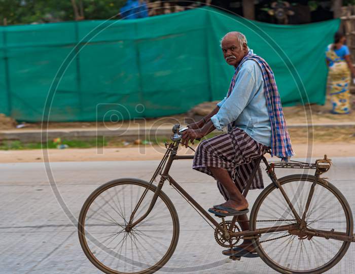 Old man riding a bicycle