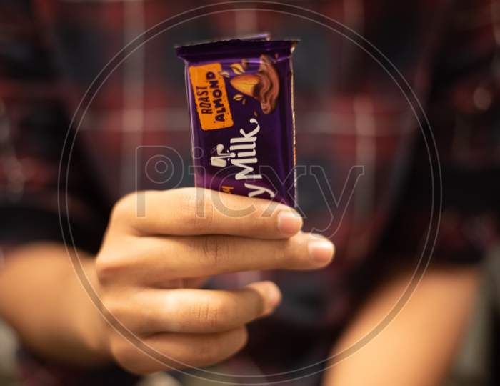 a man holding a Cadbury chocolate