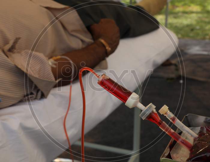 Young Man Donating Blood At a Blood Donation Camp