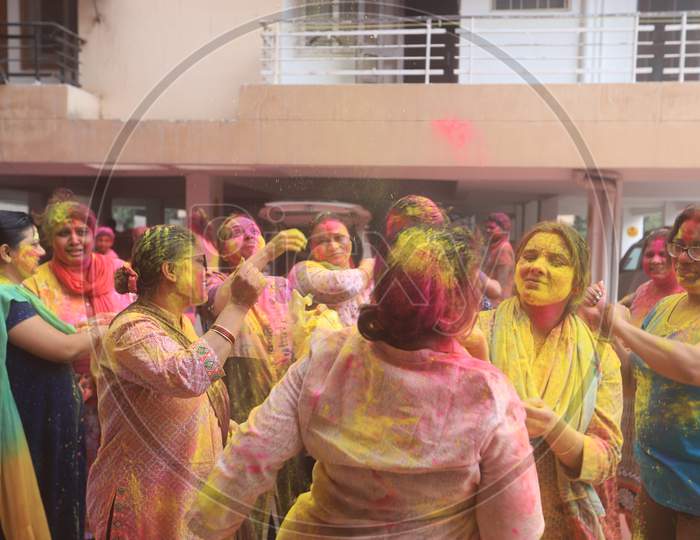Crowd Of Young Indian Woman Celebrating Holi With Colour Splash  During Holi Festival