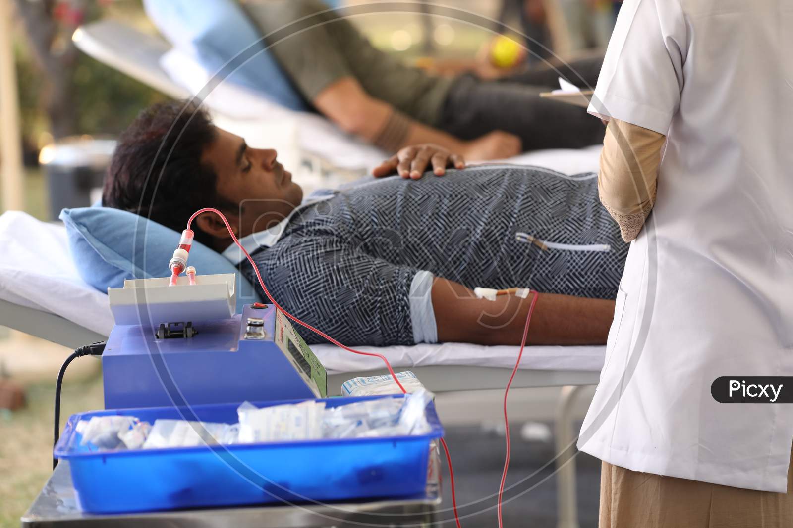 Young Man  Donating Blood At a Blood Donation Camp