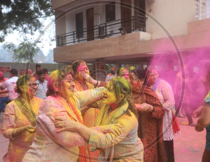 Crowd Of Young Indian Woman Celebrating Holi With Colour Splash  During Holi Festival
