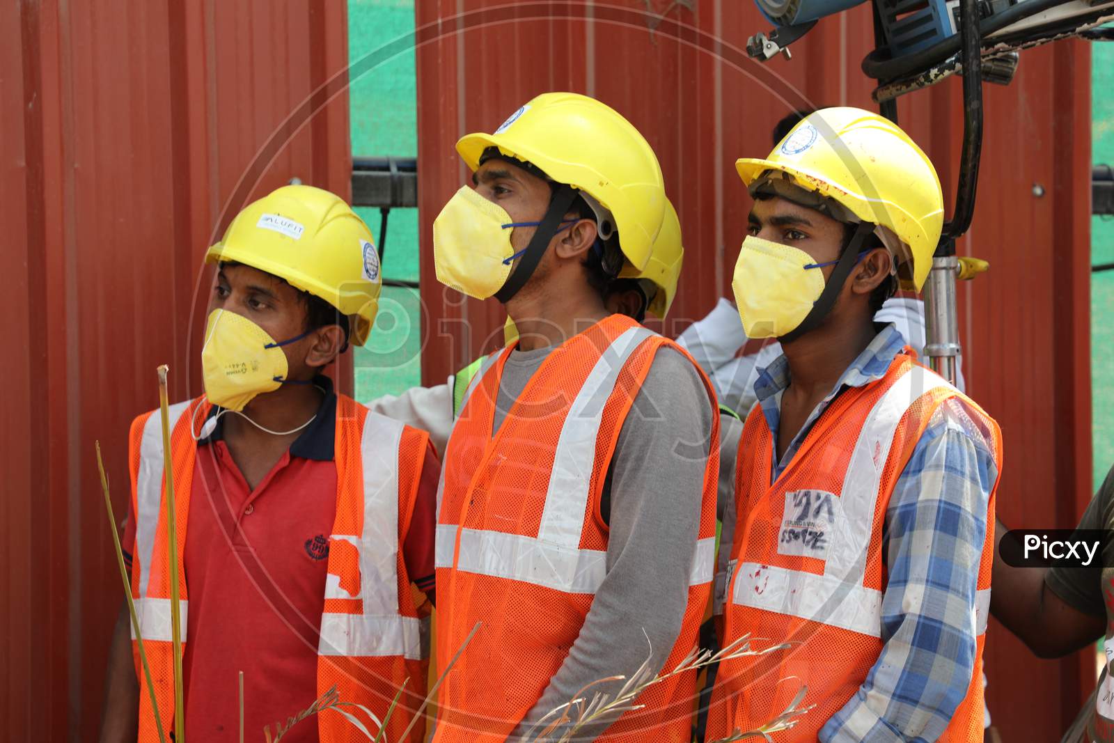 Construction Workers Wearing Safety Helmets And masks At a Construction Site