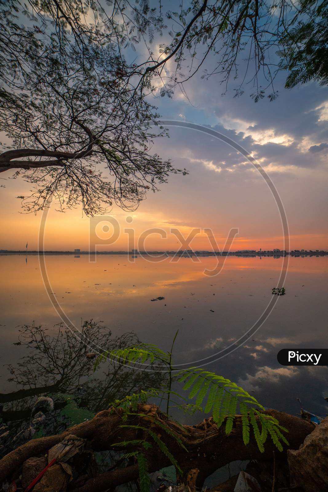 A View Of Lake With sunset Sky In Background