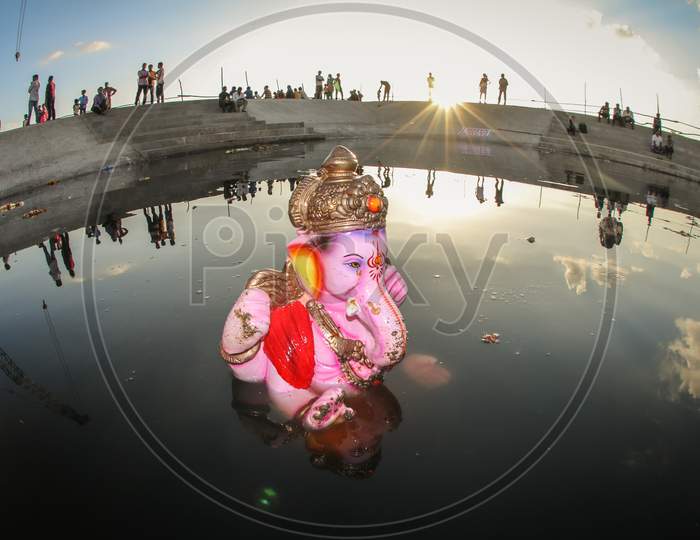 Lord Ganesh Idols During Visarjan or Nimarjan Or Immersion  Half Submerged In Water