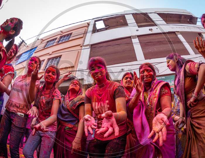 Indian  Young People Playing Holi  Celebrations With Colour Splash
