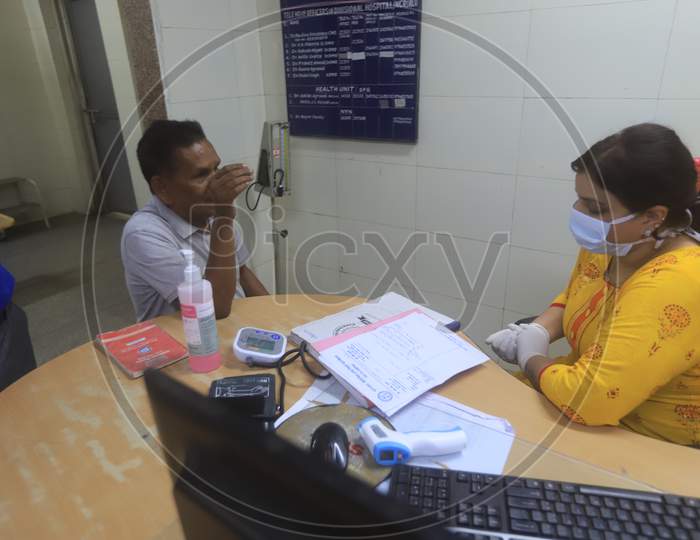 Doctor Checking A Patient  Wearing Mask Amidst Corona Virus Outbreak With an Thermal Senor
