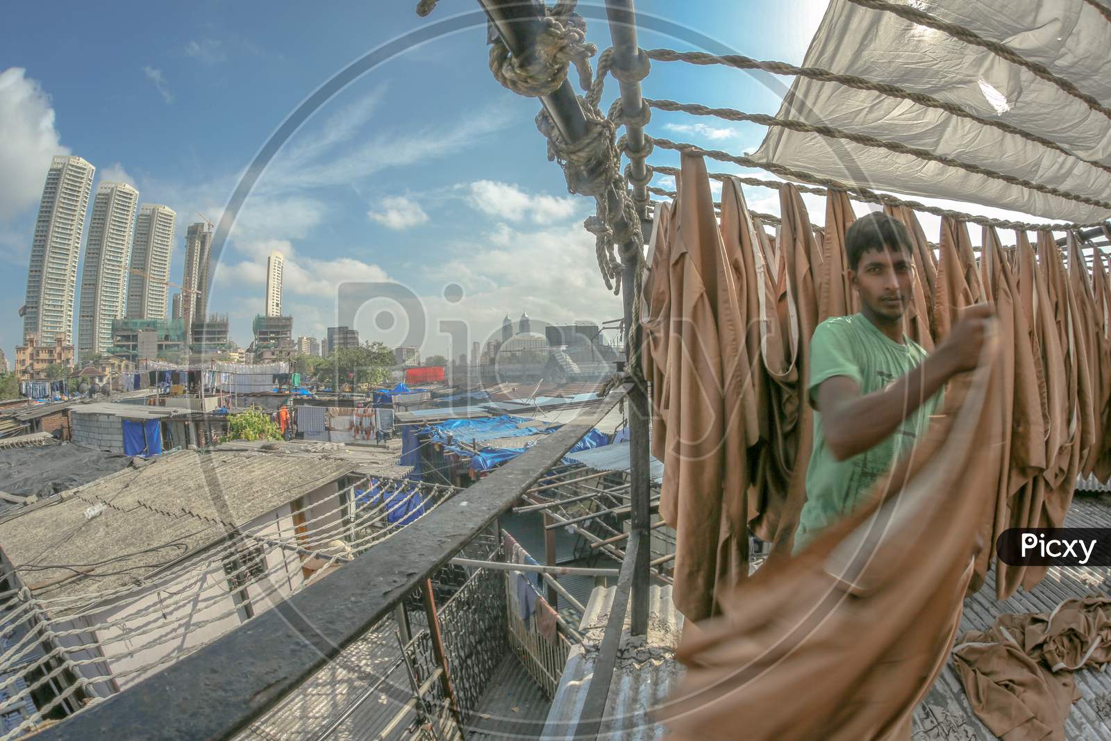 A Washerman or Dhobi Washing Clothes in an Urban City