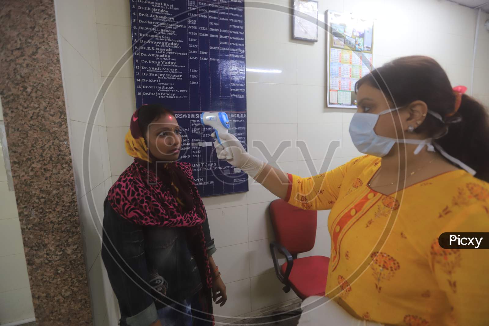 Doctor Checking A Patient  Wearing Mask Amidst Corona Virus Outbreak With an Thermal Senor