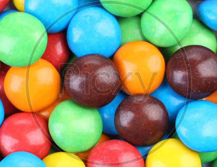 Backgroynd Of Chocolate Balls In Colorful Glaze. Whole Background