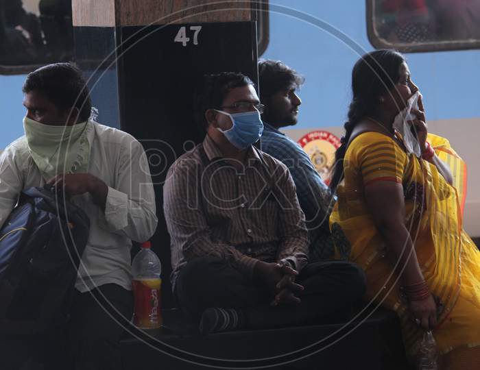 Passengers waiting for train with face masks on